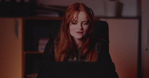 Young Woman Working at Night Video Conference