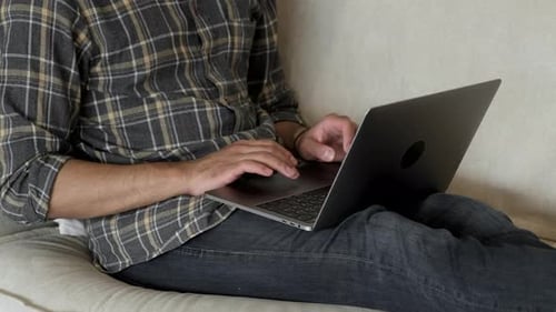 Close up of a focused and serious man working from home. Slow motion, handheld