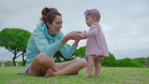 Happy Little Baby Girl Playing Together with Her Mother Outdoor in the Park Adorable Baby Lifestyle