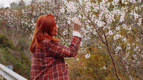Happy Redhaired Girl Touch Spring Flower Tree