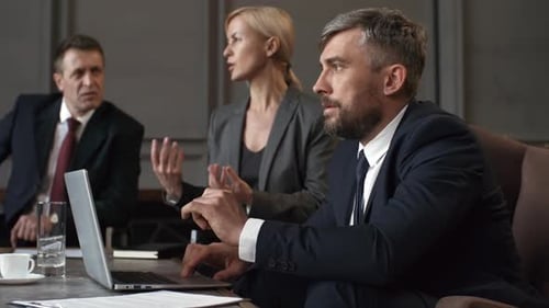 Corporate Executives in Suits Participating in Meeting