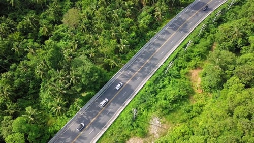 Aerial View of Transport Moving Along Road on Tropical Island in Thailand