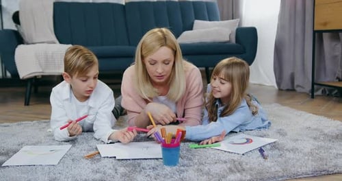 Woman and Children Drawing Together on Living Room Floor