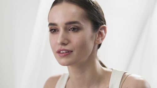 Woman Massaging Her Face Gently Smiling Close Up