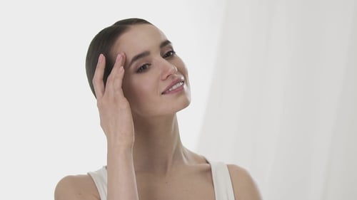 Woman Massaging Face in Health and Beauty Concept
