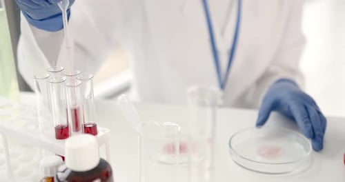 Scientist Uses Pipette in Medical Research Laboratory
