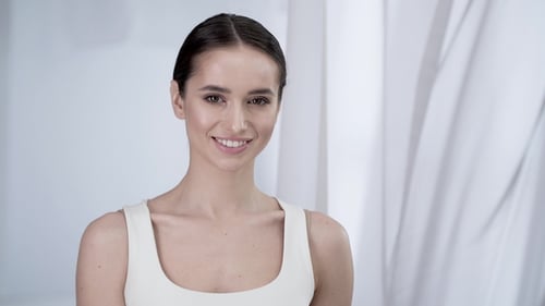 Smiling Young Woman Portrait in a White Room