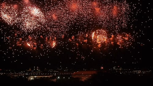 Fireworks Explode over Sparkling City at Night