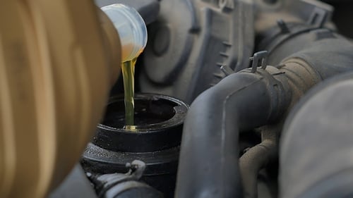 Adding Oil to Car Engine Close Up