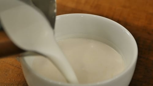 Milk Being Poured Into White Ceramic Mug