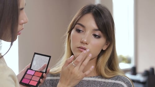 Woman Getting Lip Makeup Applied in Studio