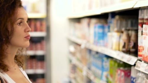 Girl Buying Dairy at the Supermarket
