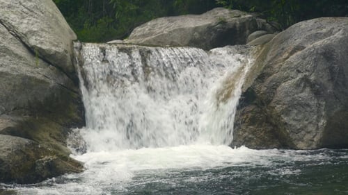 Beautiful Waterfall Flowing on Large Stones in Mountain River. Flow Mountain River in Waterfall
