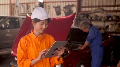 Portrait of a Young Beautiful Car Mechanic in a Car Workshop.