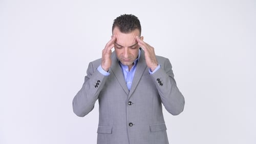 Stressed Man in Suit Rubbing Head