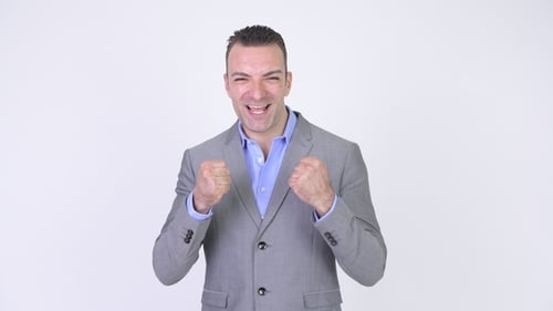 Successful Businessman With Arms Raised Smiling