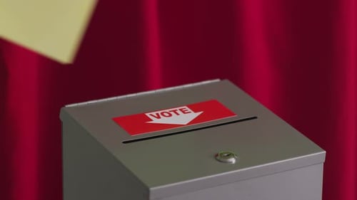 Putting a Ballot into Vote Box Close Up