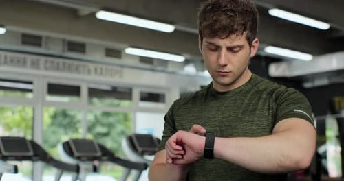 Man Using a Smart Watch in Gym