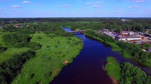 Aerial View of Rural Settlement and Bridge Crossing the River in Russia