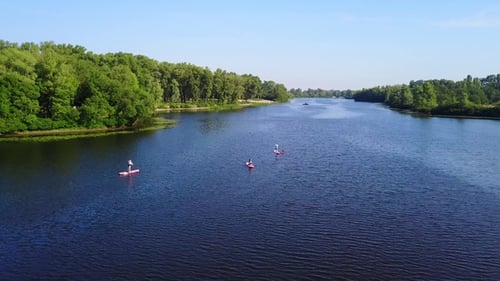 Three Young People Are Kayaking on the River