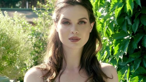 Woman in Green Foliage with Fashionable Dress