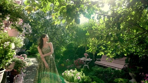 Elegant Woman in Gown Posing in Lush Garden