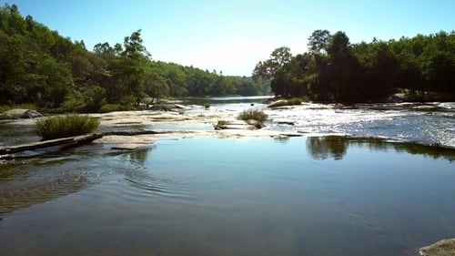 Mountain River Rapids Run Among Rocks Under Sunlight