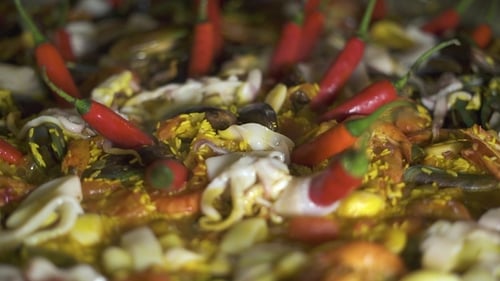 Traditional Spain Food Paella with Mussels, Shrimps, Calamari and Vegetables in Pan. . Cooking