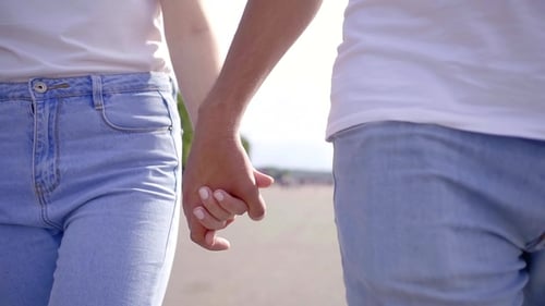 Romantic Couple Holding Hands Walking in Urban Park