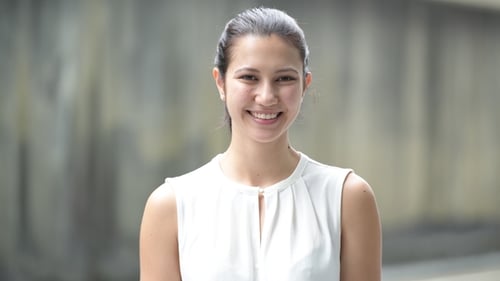 Smiling Young Adult Woman Looking at Camera