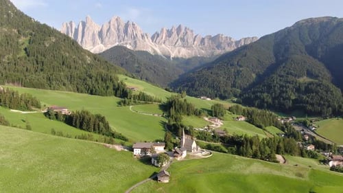 Aerial view of famous Church of Santa Maddalena in Dolomites mountains, Italy