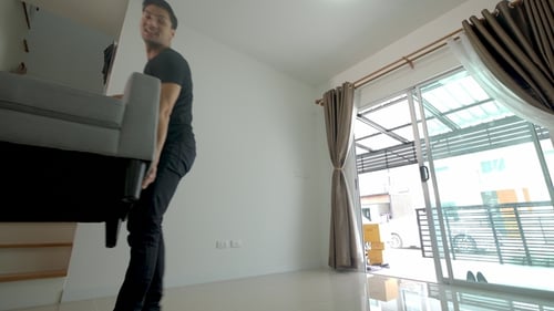 Couple Moving Couch Into New Home