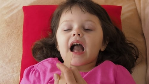 Child Throat Examination Using Tongue Depressor