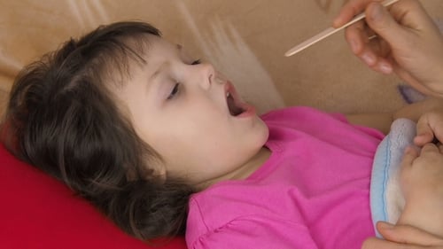 Examining a Child's Throat with Tongue Depressor