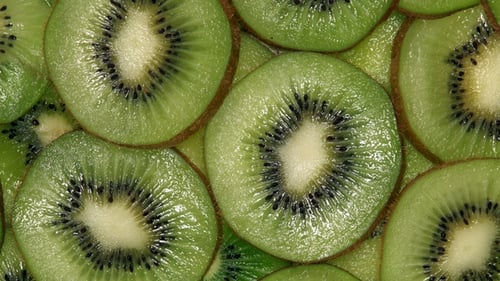 Slices of Kiwi Fruit Rotating on Turntable