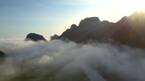 Calm River Under Foggy Clouds Against Hills Before Sunrise