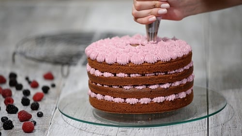 Decorating Layer Cake With Pink Icing Close Up