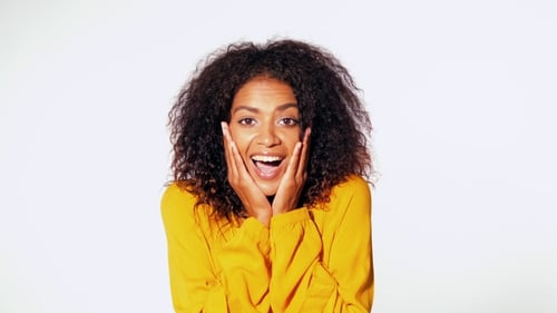 Beautiful African American Woman with Afro Hair in Yellow Wear Smiling, Pleasantly Surprised To