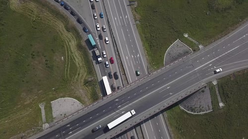 Aerial Shot of City Road Traffic Over Big Crossroad. Cars, Buses and Trucks Driving By Avenue