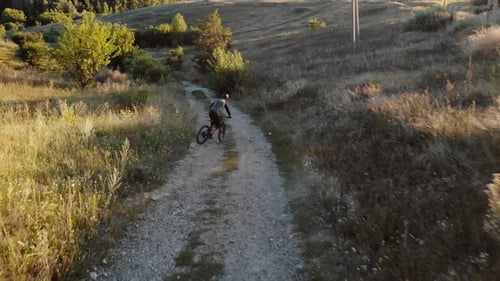 Aerial View of Cyclist Walking Down Mountain Road