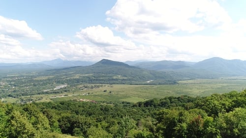 Aerial View - Beautiful Green Valley, River, Mountains and Village.