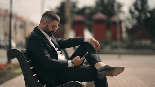 Businessman on Streets of District and Using Mobile Phone