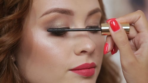 Woman Having Mascara Applied in Close Up Shot