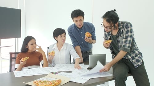 Casual Creative Business Team Having Lunch While Meeting in Office