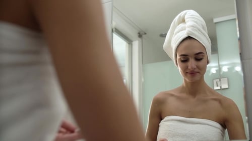 Skin Care. Woman Cleaning Face With Lotion At Bathroom