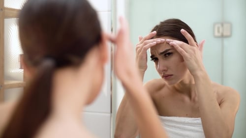 Problem Skin. Woman Crushing Spot On Face And Looking In Mirror