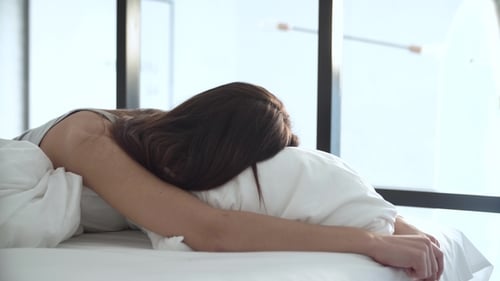 Woman Laying in Bed in Daytime