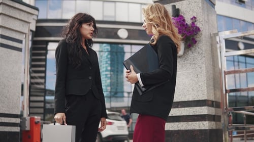 Professional Women Discussing Business Outside Office Building