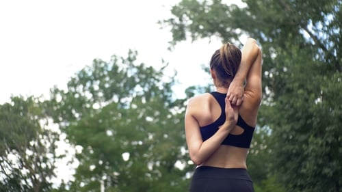 Young Athlete Woman in Sport Outfit Engaged in Fitness on the Sports Field in the Park