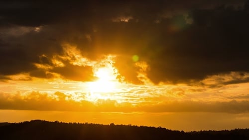 Silhouette of Dark Meadow Against Sunset or Dawn Background